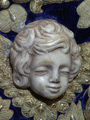 Cabecita de ángel, tallada en naranjo, del manto de Nuestra Señora de la Amargura