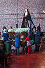 En la mañana del Lunes Santo mujeres y niños se afanan en colocar las flores del paso de Nuestra Señora de Amor y Sacrificio
