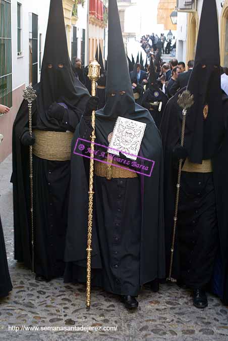 Nazareno que porta el Libro de Reglas de la Hermandad del Mayor Dolor